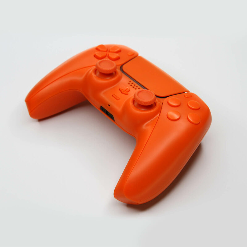 Front right angled view of Orange PS5 controller