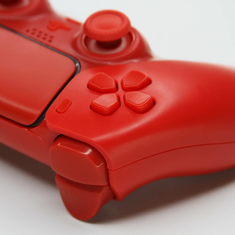 Close up of directional pad on all red ps5 controller