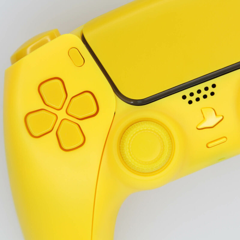 Close up of directional pad on fully yellow ps5 controller