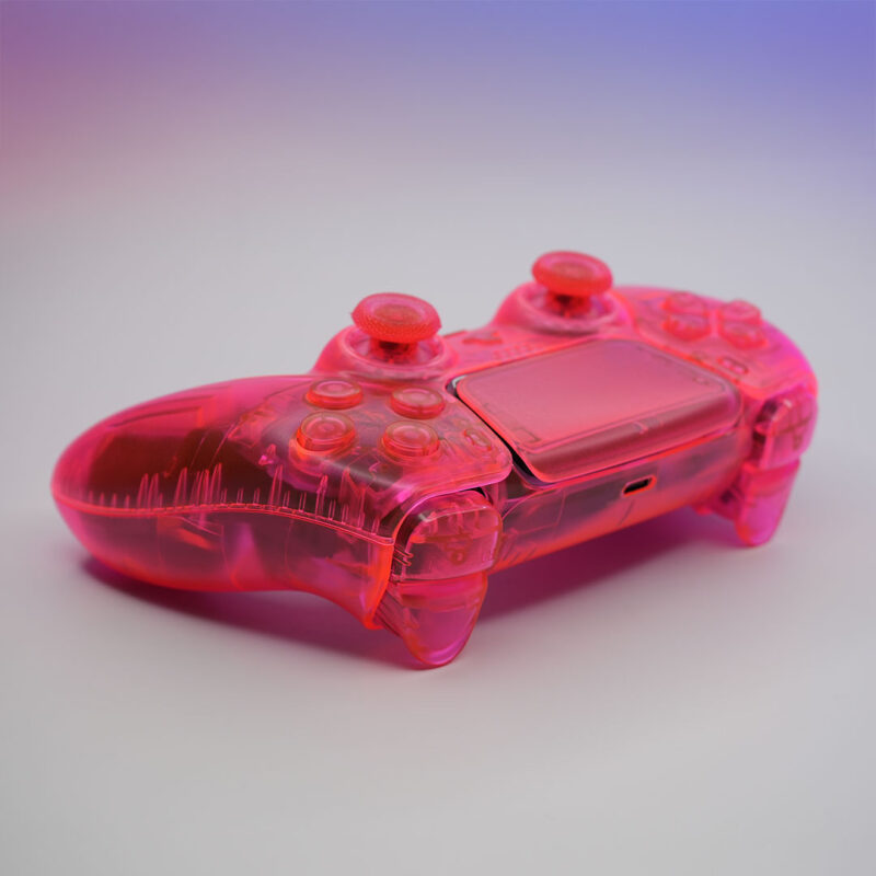 Top-down view of the custom DualSense controller highlighting the neon pink buttons and touchpad.