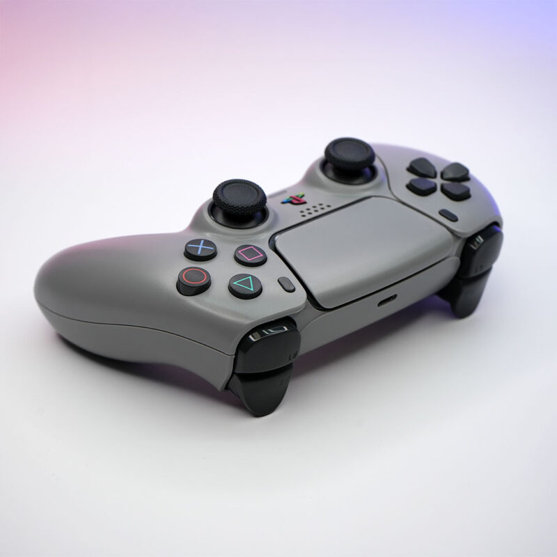Angled view of 1080R PS1 Retro Grey DualSense 30th Anniversary PS5 Controller